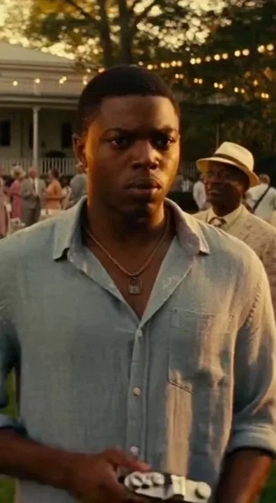 Remix of @mike-visions
A cinematic 15-second tracking shot at an elegant outdoor garden party during the golden hour. The scene begins with a close-up of an African American young man in a casual blue linen shirt looking uneasy. He takes a photo with a vintage camera, and the bright flash illuminates the face of another man dressed in a 1950s-style straw hat and patterned blazer. Immediately after the flash, the man in the hat experiences a jarring emotional shift; his polite smile vanishes, replaced by wide-eyed, frantic terror. Tears stream down his face as he lunges forward, grabbing the younger man’s shoulders and screaming a desperate warning. The background guests, dressed in wealthy summer attire, frozen in shock. High-contrast lighting, shallow depth of field, 4k, hyper-realistic textures, and intense emotional drama."